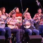Frail Away Ladies consisting of Ellie Sharman, Kate Boesser, Devin Tatro, Katie Henry, Erin Tilly, Heidi Kristenson, Emma Carr, Erin Heist and Annie Bartholomew take to the stage with banjos in hand for Saturday nights performance at this years Folk Fest in the JDHS auditorium. (Jonson Kuhn / Juneau Empire)