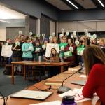 Juneau District School board and administrators listen to Jess Cobley, Juneau Education Association middle school representative at large, as she speaks about the contract negotiations during a December meeting at Thunder Mountain High School. (Clarise Larson / Juneau Empire)