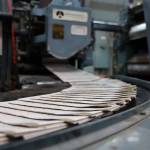 Freshly printed paper makes it way through the Juneau Empire printing press in Juneau Thursday evening. Beginning May 3, the Juneau Empire will be printed in Washington state, and delivered on Wednesdays and Saturdays. (Clarise Larson / Juneau Empire)