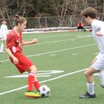 Xavier Melancon, a JDHS junior, maneuvers past a Thunder Mountain High School player on the pitch at the Adair-Kennedy field Monday evening. (Courtesy Photo / Dana Zigmund)