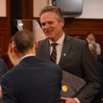 Alaska Gov. Mike Dunleavy shakes the hands of state legislators as he prepares to deliver the 2023 State of the State address to the Alaska Legislature on Jan. 23, 2023, in Juneau. (James Brooks/Alaska Beacon)