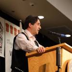 The Central Council of the Tlingit and Haida Indian Tribes of Alaskas representing attorney Philip Baker-Shenk gives a speech Wednesday during the first day of Tlingit and Haidas 88th annual Tribal Assembly. Baker-Shenk addressed the state of Alaskas recent lawsuit against the federal governments approval of the first parcel of land owned by the tribe. (Clarise Larson / Juneau Empire)