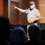 Alan Cleveland shares his experiences as a Juneau taxi driver to a packed house at Ḵunéix̱ Hídi Northern Light United Church as part of Mudrooms final showcase of the season on Tuesday night. (Jonson Kuhn / Juneau Empire)
