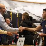 Kyle Khaayákw Worl, an athlete and coach for Team Alaska at the 2023 Arctic Winter Games in February, shakes hands with City and Borough of Juneau Deputy City Manager Robert Barr Monday night. Worl competed in Arctic Sports.