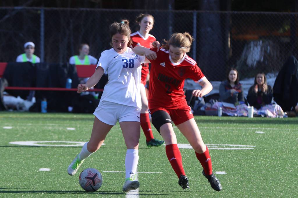 TMHS junior Adella Dihle (38) defends the ball from JDHS junior Finley Sullivan on Tuesday during the second conference game of the season for the two cross-town rivals. (Jonson Kuhn / Juneau Empire)
