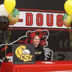 JDHS senior Mariah Schauwecker sits before friends and family on Wednesday at the JDHS gymnasium to sign a letter of intent to play softball with Southern Idaho. (Jonson Kuhn / Juneau Empire)