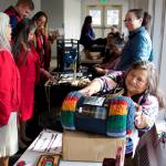 Cindy Pederson, sets up a display table for raffle items in a hallway at Elizabeth Peratrovich Hall during the 88th annual Tribal Assembly of the Central Council of the Tlingit and Haida Indian Tribes of Alaska. Pederson, a Seattle resident and delegate for nearly 20 years until taking a job with the tribes COVID-19 relief program last year, was named the tribes Delegate/Citizen of the Year on Thursday. (Mark Sabbatini / Juneau Empire)