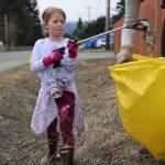 Catherine Berry, 6, places litter in a bag held open by her mother, Mary, during a communitywide cleanup held on Earth Day. The cleanup of public lands is an annual event organized by Litter Free Inc. (Ben Hohenstatt / Juneau Empire)