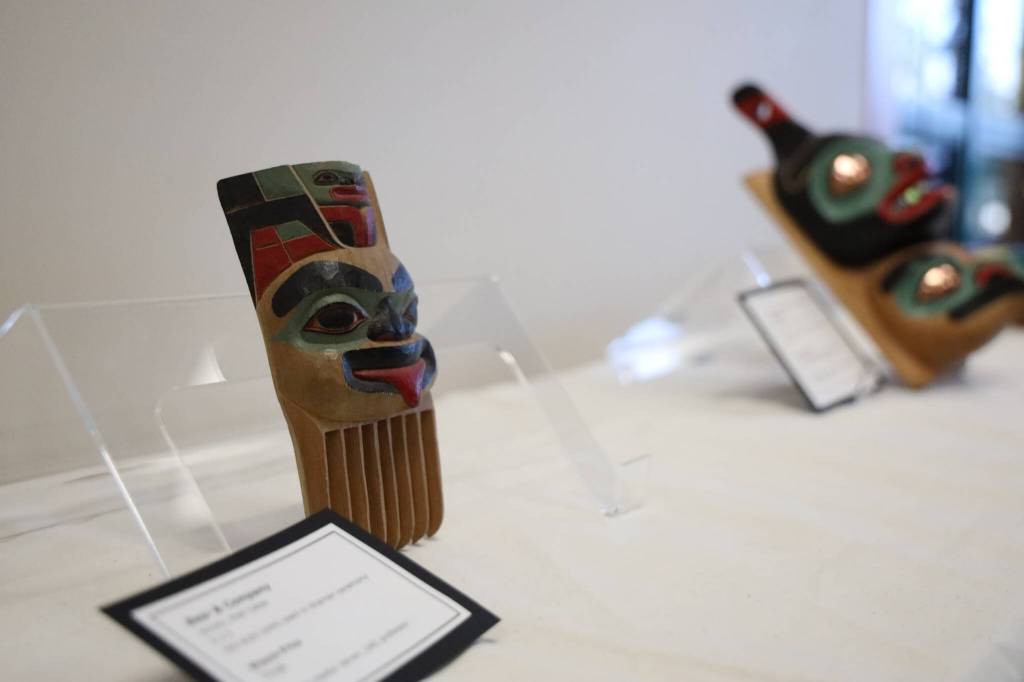 This piece titled Bear & Company was carved by Tlingit master carver Wayne Price and was one of the many pieces featured in a recent art gallery hosted Friday evening at the University of Alaska Southeast that showcased students work from the UAS Northwest Coast Art program, of which Price teaches. The carving is of an old-style comb used in shaman ceremonies. (Clarise Larson / Juneau Empire)