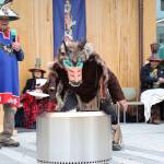 Kaax̱ḵaatuklag̱é Ken Grant sings a song as Ben Coronell performs a thanking and feeding the spirits of the trees ceremony during the dedication ceremony of the Kootéeyaa Deiyí, Totem Pole Trail, held Saturday in downtown Juneau at Heritage Plaza. (Clarise Larson / Juneau Empire)
