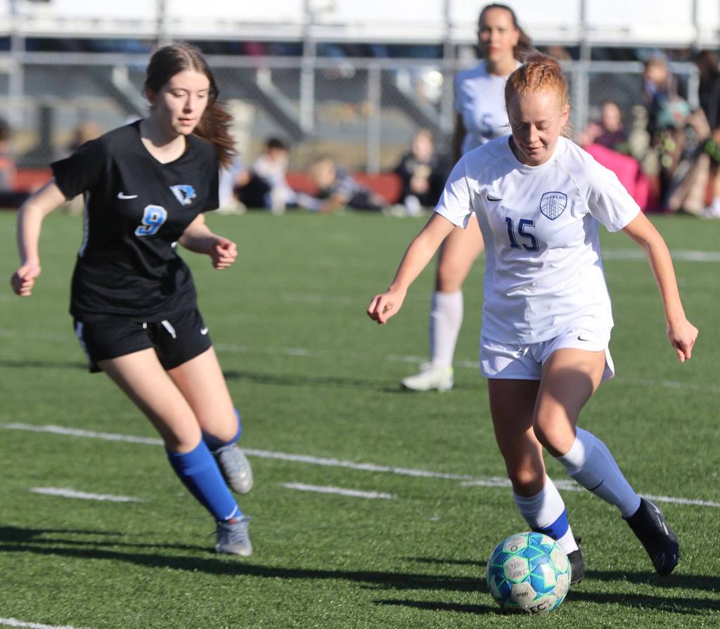 Wheat Ridge senior Ella Strafface (15) defends the ball against TMHS freshman Piper Blackgoat (9) on Thursday against Thunder Mountain for a non-conference game. Strafface had two goals against JDHS on Saturdays game at Adair Kennedy field. (Jonson Kuhn / Juneau Empire)