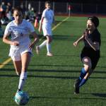 TMHS freshman Tuvy Vu (22) pursues Wheat Ridge Naomi Fireman Schiavoni (4) near the the Falcons goal line on Thursday for a non-conference game. Colorado visited Juneau for two non-conference games against both Juneau high schools. (Jonson Kuhn / Juneau Empire)