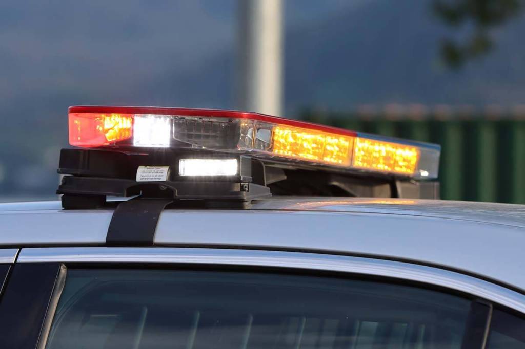 Emergency lights flash on top of a police car. (Ben Hohenstatt / Juneau Empire File)