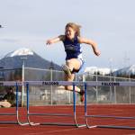 Thunder Mountain High School senior Mallory Welling launches over a hurdle during the 300 meter hurdle prelims at the Capital Invitational Track and Field meet Friday evening. (Clarise Larson / Juneau Empire)
