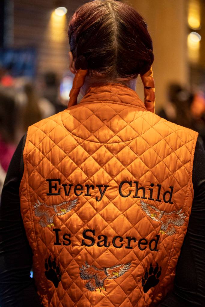 A person wears a vest that says Every Child Is Sacred during a Road to Healing event at the Tulalip Gathering Hall in Marysville, Washington on Sunday, April 23, 2023. The tour is lead by United States Secretary of the Interior Deb Haaland and Department of the Interior Assistant Secretary Bryan Newland. (Annie Barker / The Herald)