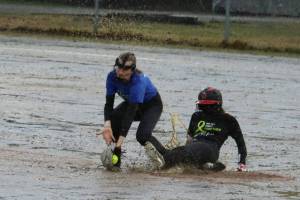 JDHS Gloria Bixby slides safe into second base and under the tag of TMHS Jenna Dobson during the first inning of a drizzly Friday night game against Thunder Mountain High School in May 2021 that raised money for mental health. TMHS and JDHS both will be participating in the Paint it Pink Cancer Awareness games on Saturday, May 13 along with Ketchikan and Sitka high schools at Melvin Park and Dimond Park Field No. 4 (Ben Hohenstatt / Juneau Empire File)