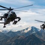 In this photo released by the U.S. Army, AH-64D Apache Longbow attack helicopters from the 1st Attack Battalion, 25th Aviation Regiment, fly over a mountain range near Fort Wainwright, Alaska, on June 3, 2019. The U.S. Army says two Army helicopters similar to the ones in this picture crashed Thursday, April 27, 2023, near Healy, Alaska, killing three soldiers and injuring a fourth. The helicopters were returning from a training flight to Fort Wainwright, based near Fairbanks. (Cameron Roxberry / U.S. Army)