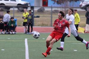 JDHS junior Oliver Zigmund (15) blocks a shot at Adair-Kennedy Field on Saturday against Ketchikan High School for the Bears first two conference games of the season. Zigmund puts in extra playing time by playing with both the JV and varsity team. (Jonson Kuhn / Juneau Empire)