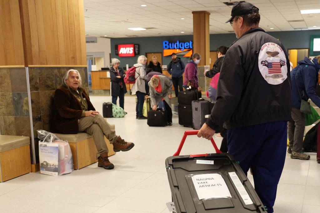 A black tote holding Alaska Native artifacts sits on the ground of the Juneau International Airport on Nov. 17, 2022. It was flown from Seattle after being filled with 25 Alaska Native artifacts held at George Fox University in Oregon. (Clarise Larson / Juneau Empire)