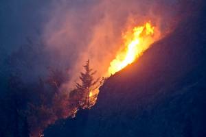 Flames are visible from the Beluga Point parking area near Anchorage on July 19, 2016, as a wildfire near McHugh Creek burns. A recent series of wildfires near Anchorage and the hottest day on record have sparked fears that a warming climate could soon mean serious, untenable blazes in urban areas  just like in the rest of the drought-plagued American West. (Marc Lester / Anchorage Daily News)