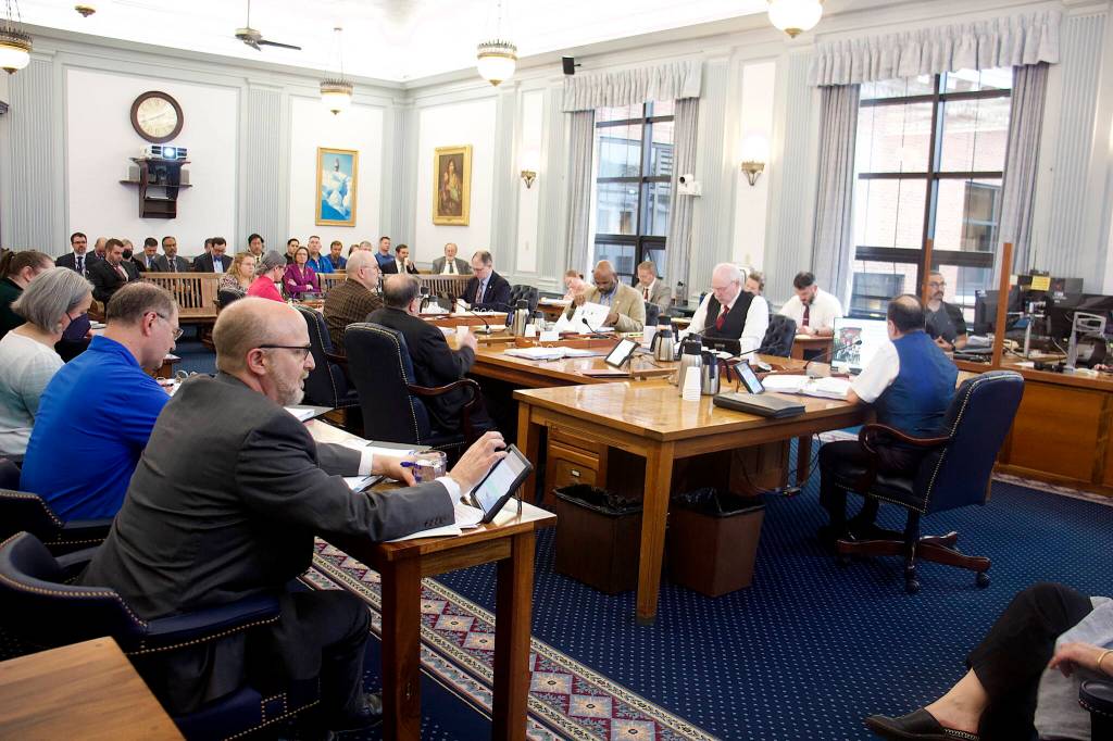 Legislators, their staff, union leaders and state employees crowd into a Senate Finance Committee meeting on Tuesday afternoon, where detailed testimony was offered about the fine points of a bill that would boost state employee pensions. (Mark Sabbatini / Juneau Empire)