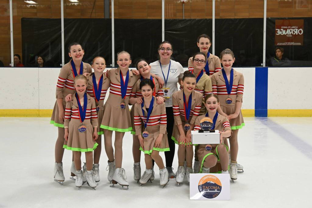 Team Fireweed, Juneau Skating Clubs youth synchronized skating team, poses for a group photo with coaches Emily Bowman and Pam Leary after taking first place in the first place in that event at this years Ice Sports Industry West Coast Championship in Tacoma, Washington. (Courtesy Photo / Marianne Oelund)