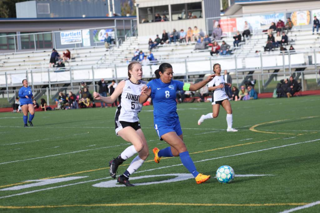 Thunder Mountain High Schools Mercedes Cordero (8) and Juneau-Douglas High School: Yadaa.at Kalés Peyton Wheeler (5) jockey for the ball at TMHS. (Ben Hohenstatt / Juneau Empire)