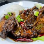 Adobong Manok, chicken thighs cooked in garlic, soy sauce, and vinegar, from Golddigger Filipino Restaurant. (Lauren Cusimano / For the Capital City Weekly)