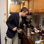 Ryan Rivers, a Senate page, makes coffee by the urn in the pages’ office of the Alaska State Capitol on Wednesday morning. The pages, along with most other people working in the building, are preparing to work a long day that could last until past midnight as the Legislature tries to resolve its differences and pass a budget on the final scheduled day of the session. (Mark Sabbatini / Juneau Empire)