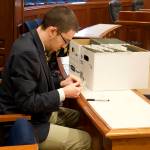 Ryan Rivers, a state Senate page, prepares file folders for proposed amendments to the state budget bill the Senate is scheduled to consider during its floor session Monday. (Mark Sabbatini / Juneau Empire)