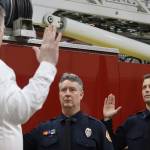 CCFR Richard Etheridge swears in Captain John Adams and Engineer Sam Berni during their badge pinning ceremony at Station 1 on Thursday. (Jonson Kuhn / Juneau Empire)