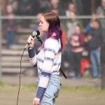 Kelsi Sell, a senior at Thunder Mountain High School, sings the national anthem Saturday at Adair-Kennedy Memorial Park during Gastineau Channel Little Leagues opening day ceremonies. (Ben Hohenstatt / Juneau Empire)