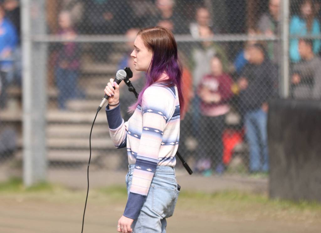 Kelsi Sell, a senior at Thunder Mountain High School, sings the national anthem Saturday at Adair-Kennedy Memorial Park during Gastineau Channel Little Leagues opening day ceremonies. (Ben Hohenstatt / Juneau Empire)