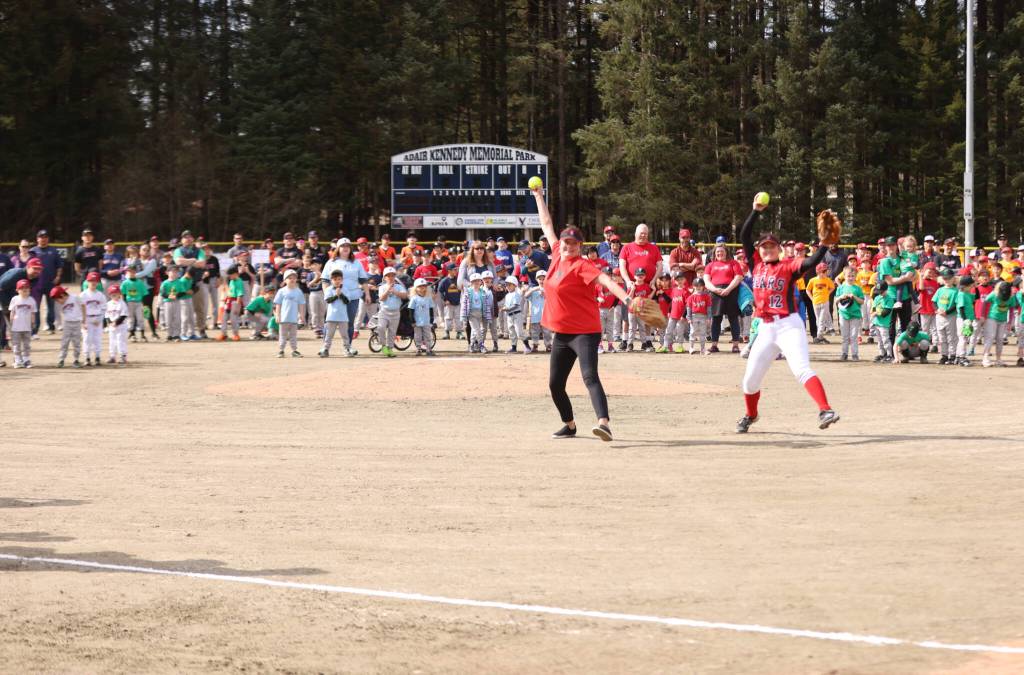 Mandy Massey and Gloria Bixby throw the first pitches of the Gastineau Channel Little League softball season on Saturday at Adair-Kennedy Memorial Park. The mother-daughter duo said some practice was needed ahead of the pitches, but the experience was unforgettable and fun. (Ben Hohenstatt / Juneau Empire)