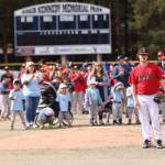 Jacob Katasse, 16, gets ready to throw the ceremonial first pitch of the Gastineau Channel Little League baseball season to his Parker Katasse, 9. The two are the great grandsons of Officer Richard Adair, one of two police officers killed in the line of duty for whom the park is named. (Ben Hohenstatt / Juneau Empire)