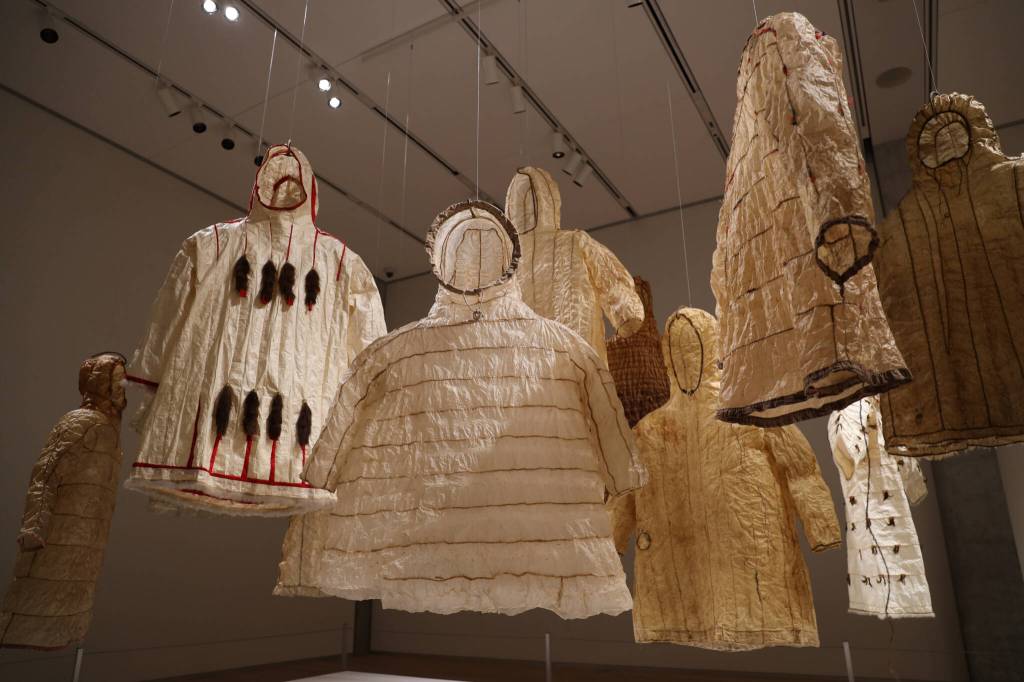 Gut raincoats made from animal intestines hang from the ceiling at the the Alaska State Museums exhibit Visceral: Verity, Legacy, Identity – Alaska Native Gut Knowledge & Perseverance. The Visceral trilogy of exhibitions displayed at the museum will be open for viewing throughout the summer. (Clarise Larson / Juneau Empire)