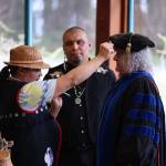 Xunei Lance Twitchell, professor of Alaska Native languages at UAS, performs a naming ceremony for retiring University of Alaska Southeast Chancellor Karen Karey during the Annual Native Graduation Celebration at the Egan Library Saturday morning before commencement. Her name, Heidé Shuwataani, means the one who opens doors. (Clarise Larson / Juneau Empire)