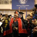 Gáanax Sháa Gloria Eyon walks down the aisle as faculty and family cheer after the 2023 University of Alaska Southeast commencement ceremony Sunday afternoon. Eyon graduated with an Associates of Arts in Northwest Coast Indigenous Arts. (Clarise Larson / Juneau Empire)