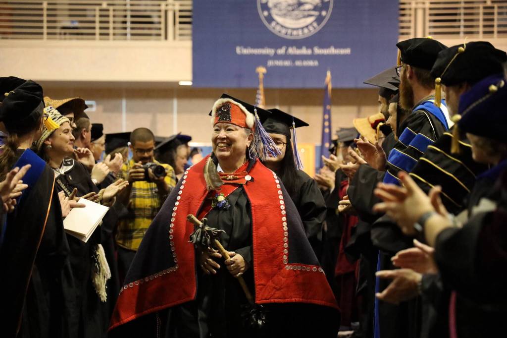 Gáanax Sháa Gloria Eyon walks down the aisle as faculty and family cheer after the 2023 University of Alaska Southeast commencement ceremony Sunday afternoon. Eyon graduated with an Associates of Arts in Northwest Coast Indigenous Arts. (Clarise Larson / Juneau Empire)