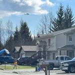 A TEMSCO helicopter flies above neighborhood near River Road Trail on Saturday as crews assisted with extinguishing a grass fire east of Montana Creek Bridge. (Courtesy Photo / CCFR Facebook)