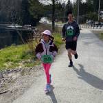 Amelin Kreuger (3926), 7, and Dylan Kreuger (3780) finish the 1-mile run in the Magnificent Mendenhall Mudpuddle Meet on Saturday. (Courtesy Photo / Quinn Tracy/ Heather Parker)