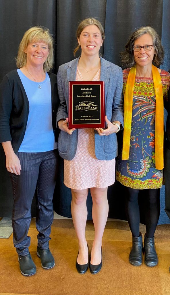Izabelle Ith, center, holds her ASAA Hall of Fame plaque with friend Jo Ann Day, left, and mother Marketa Ith, right, on Sunday at the Hall of Fame induction ceremony. (Courtesy Photo / Tommy Thompson)