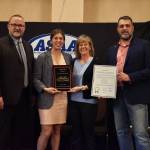 Izabelle Ith, second from left, poses with her Alaska High School Hall of Fame plaque. At left is ASAA Executive Director Billy Strickland. Second from right is Jo Ann Day, who nominated Ith for the honor. At right is Alaska state Rep. Mike Cronk who presented Ith with a legislative citation. (Brad Potter / ASAA)