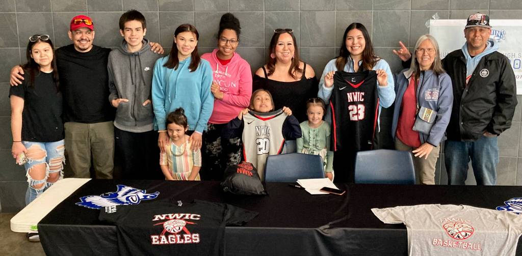 Family and friends stand with Thunder Mountain High School senior Kiara Kookesh (holding No. 23) on Monday after she signed to play college basketball for Northwest Indian College in Bellingham, Washington. (Klas Stolpe / Juneau Empire)