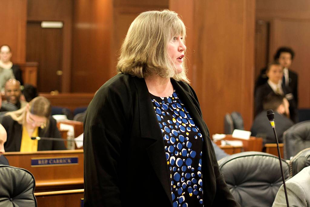 Rep. Sara Hannan, D-Juneau, speaks in opposition to the nomination of Adam Crum as the commissioner of the Department of Revenue, due to his previous job when he was commissioner of a department that since last September has been dealing with a severe backlog of processing food stamp applications. (Mark Sabbatini / Juneau Empire)