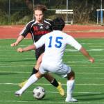 Juneau-Douglas High School: Yadaa.at Kalé sophomore Kai Ciambor (14) switches a ball against Thunder Mountain junior Reese Kugelmann (15) during the Crimson Bears 8-0 win over the Falcons, Tuesday, at Adair Kennedy Field. (Klas Stolpe / Juneau Empire)