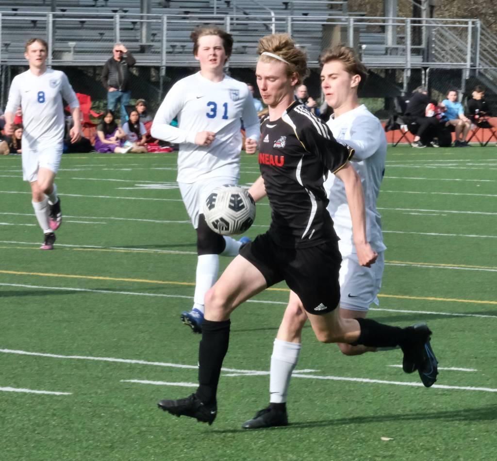 Juneau-Douglas High School: Yadaa.at Kalé senior Will Robinson wins a ball from Thunder Mountain junior Justin Scussel during the Crimson Bears 8-0 win over the Falcons, Tuesday, at Adair Kennedy Field. (Klas Stolpe / Juneau Empire)