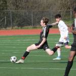 Juneau-Douglas High School: Yadaa.at Kalé senior Kean Buss stretches to advance a ball during the Crimson Bears 8-0 win over the Falcons, Tuesday, at Adair Kennedy Field. (Klas Stolpe / Juneau Empire)