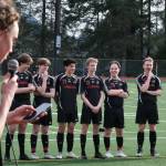 Juneau-Douglas High School: Yadaa.at Kalé  freshman Jesper Bennetsen (18) speaks about his senior brother Tayten Bennetsen (20), far right, during the JDHS boys final home game at Adair Kennedy pitch Tuesday. Seniors Jack Schwarting, Kean Buss (5), Gabe Cheng (21), Will Robinson (12), Micah Brown (23), Tommy Pearson (13) and T. Bennetsen listen. (Klas Stolpe / Juneau Empire).