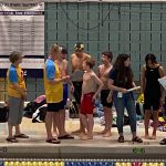 Glacier Swim Club swimmers Liam Kiessling, Sam Pallenberg, Andrew Sanders and Josh Edwards speaking to head coach Scott Griffith after the at the boys ages 13-14 relay race at this years Alaska Swimming State Championship in Anchorage. (Courtesy Photo / Savona Kiessling)
